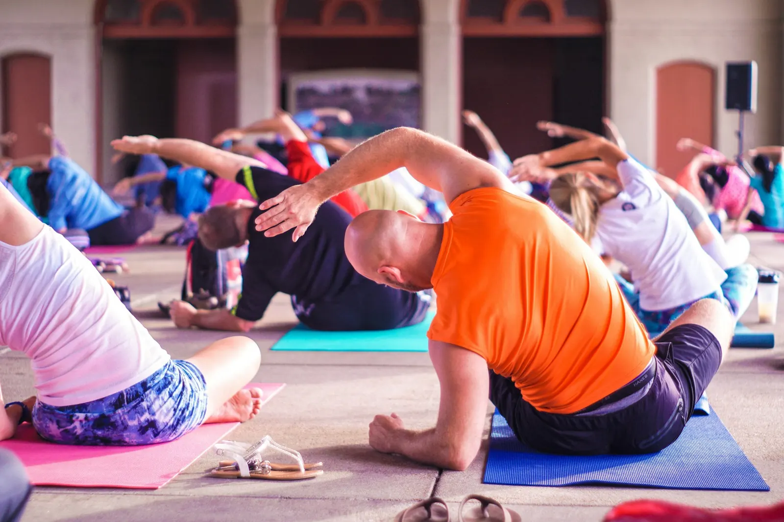 People stretching on mats in a group exercise class