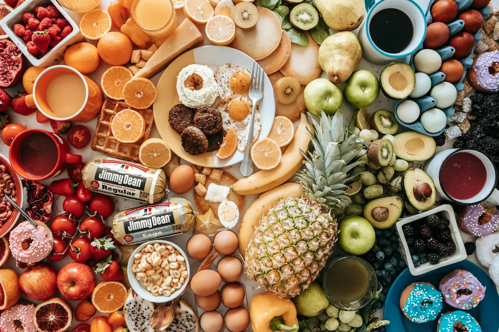 Large spread of fruit, eggs, nuts, pastries and other foods on a table