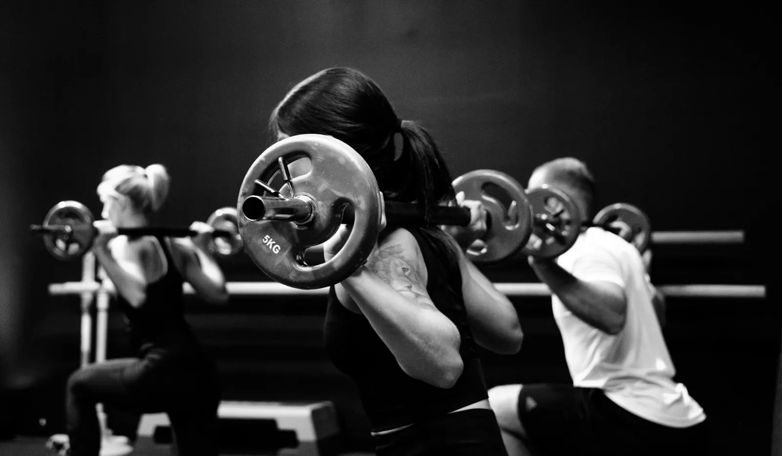Athlete training hard in a gym, black and white photo