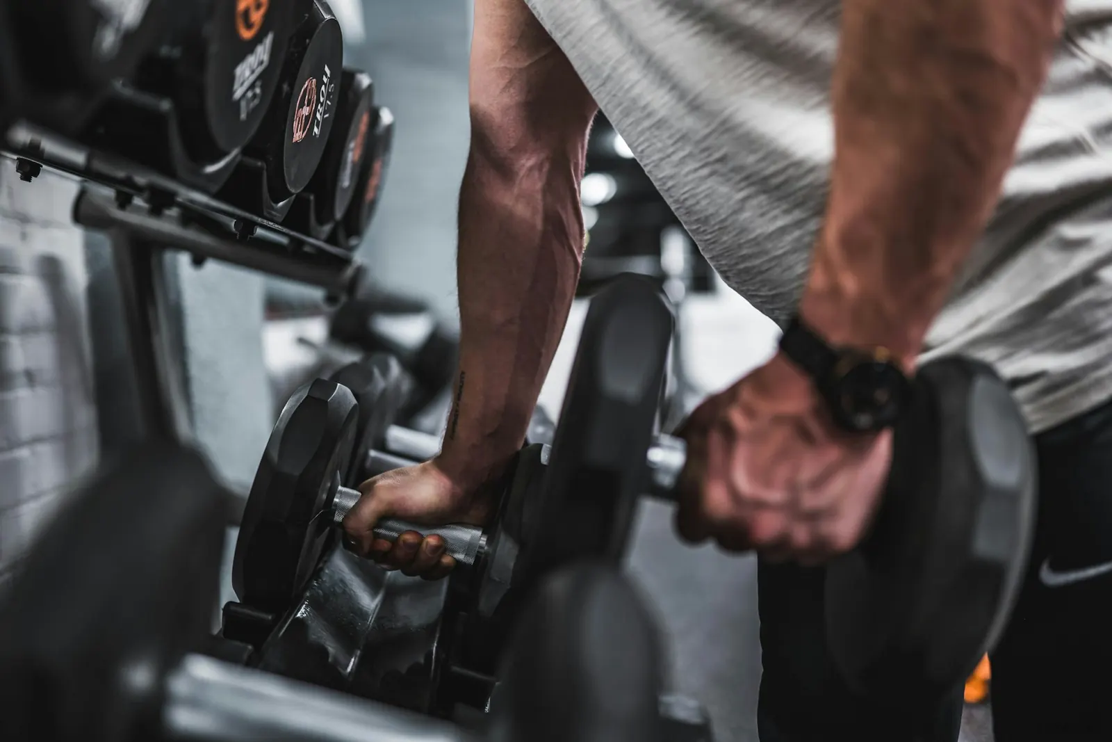 Athlete holding a heavy dumbbell during a gym workout