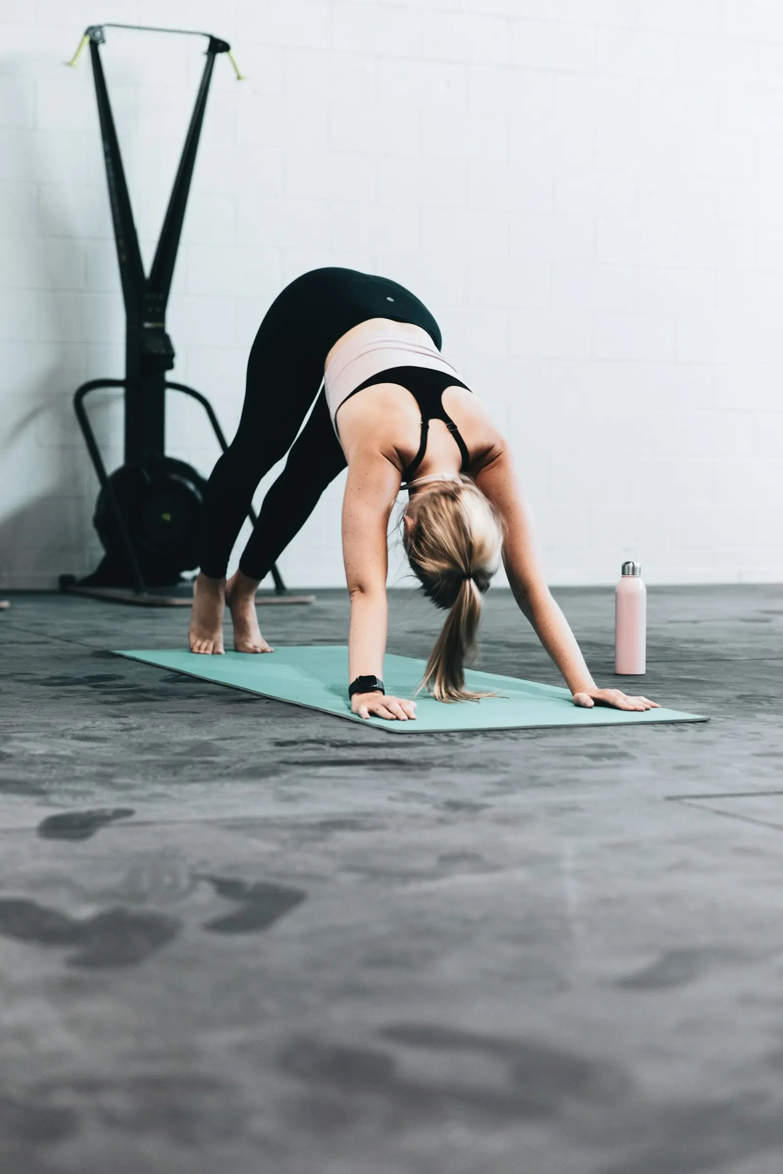 Woman exercising on a mat in a bright studio