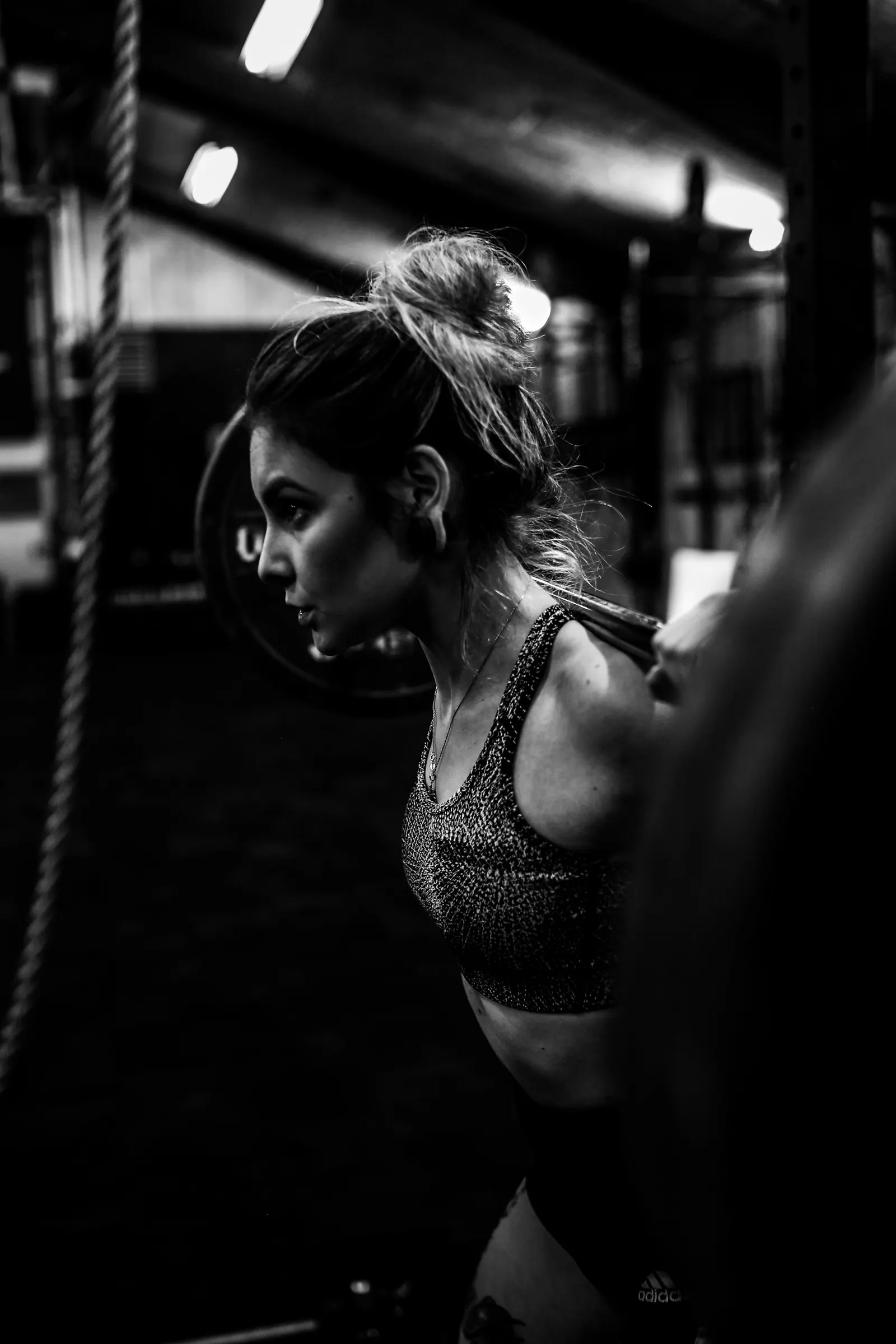 Woman training in a gym, photographed in black and white