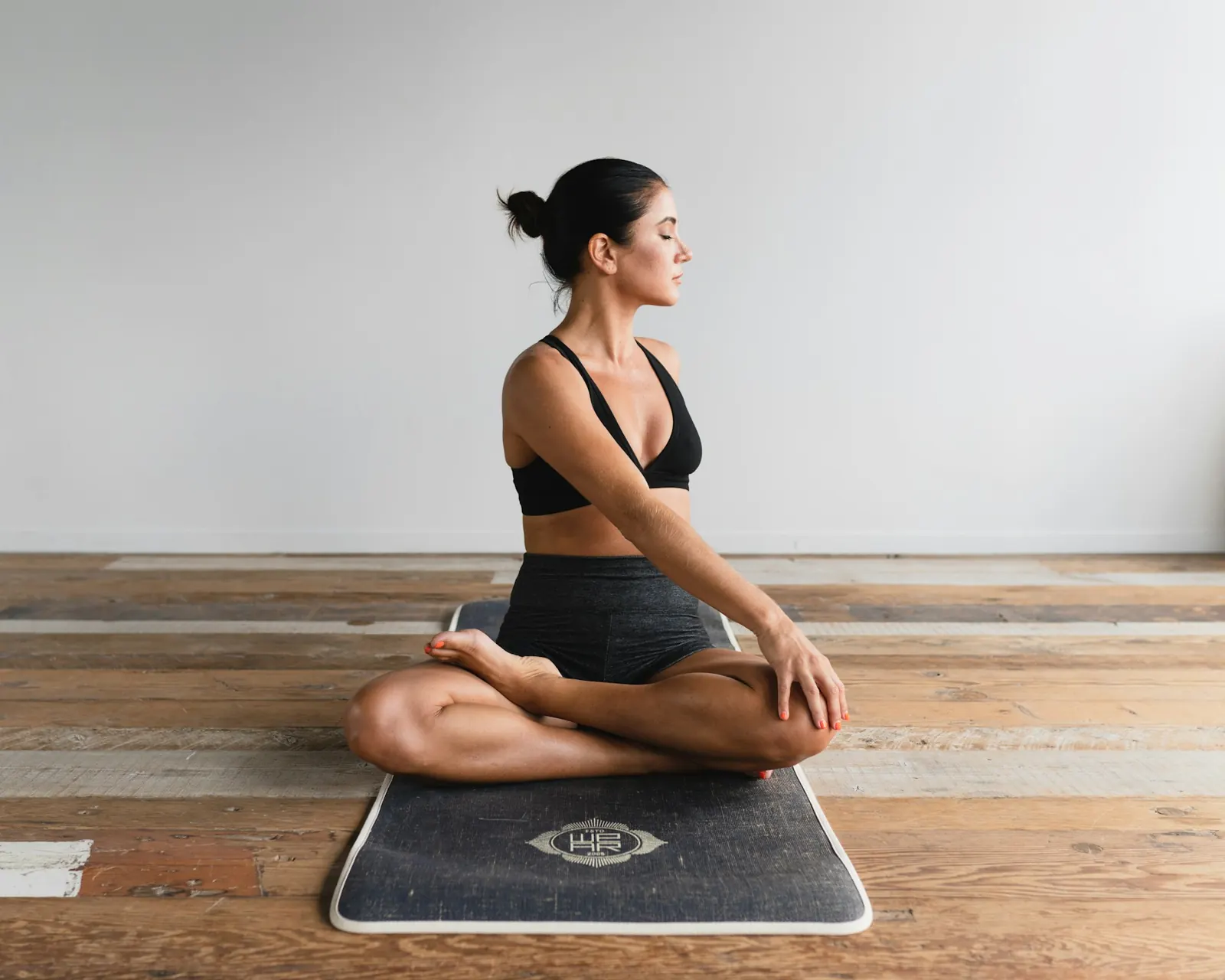 Woman sitting cross-legged practising slow breathing