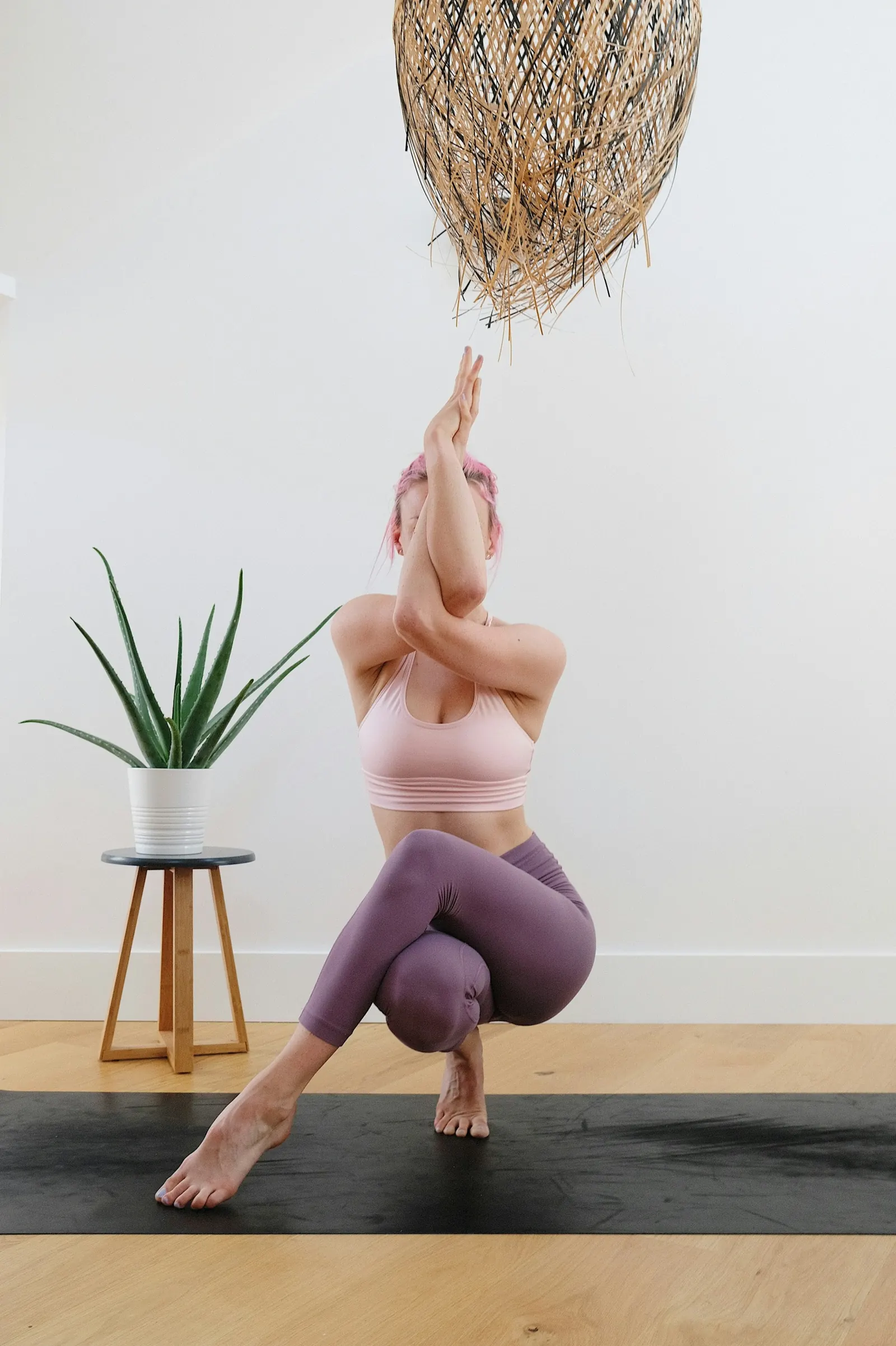 Woman balancing on her toes in a yoga pose